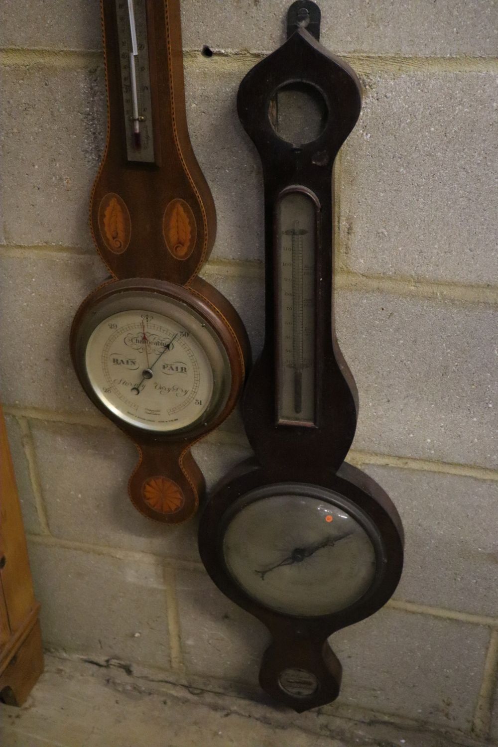 A late Victorian mirrored wall bracket and two wheel barometers